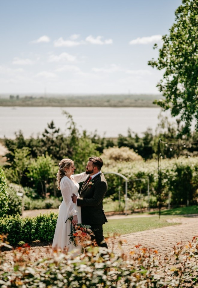 Bride and groom in the Harty Estate wedding garden, overlooking the Kent estuary