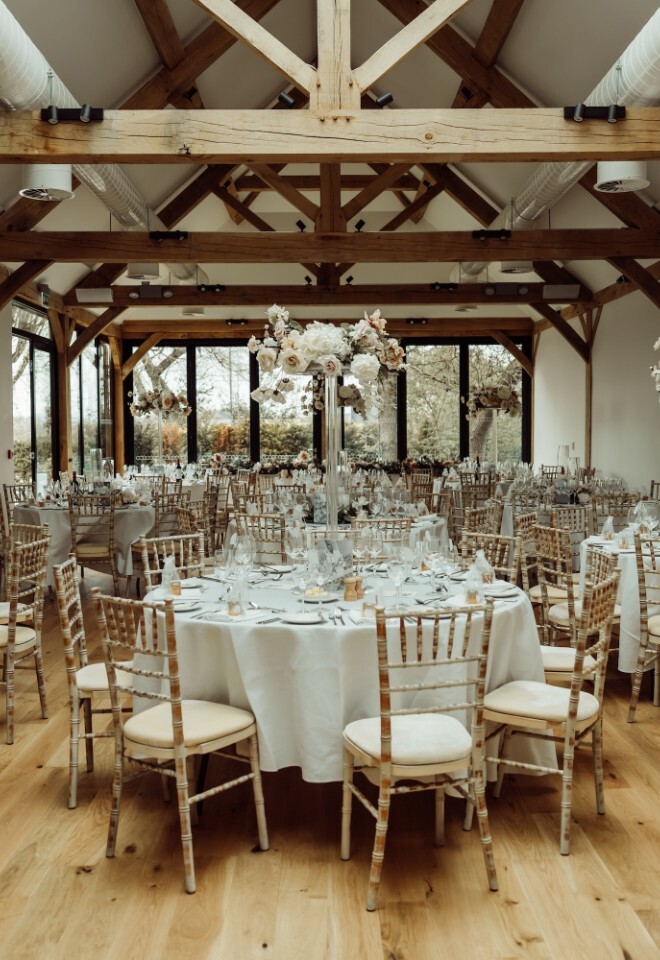 Modern barn wedding venue set up with round tables wedding for meal