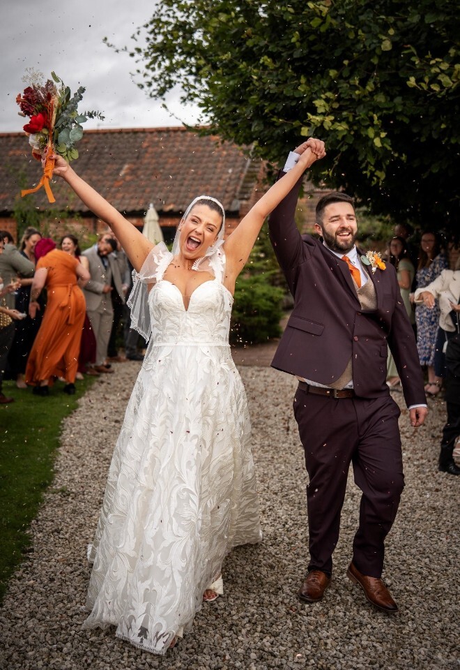 Newlyweds celebrating outdoors. Photo by Jennings Photography, Essex.