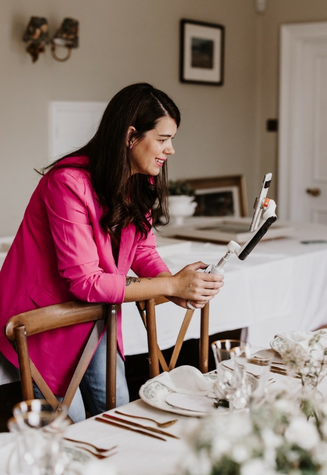 A wedding content creator based in hampshire holding a gimbal and a smartphone