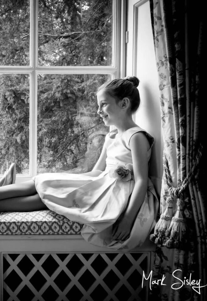 Flower girls pose for a window portrait at Hartwell House