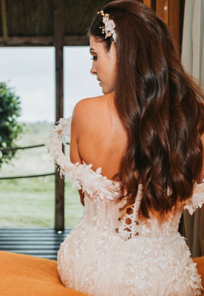 bride sittin on a bed looking at the view at Chilterns View Wedding Venue in Oxfordshire