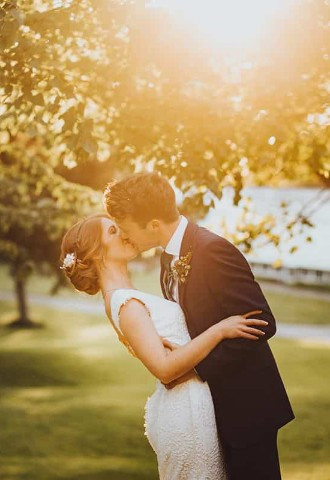 Bride and groom share a kiss at Margam Orangery, South Wales