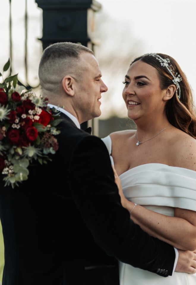 Couple embracing in the Orchard Marquee