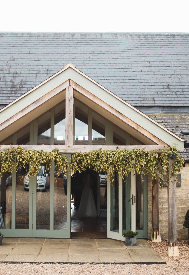 The grounds and barn at an exclusive Oxfordshire barn wedding venue