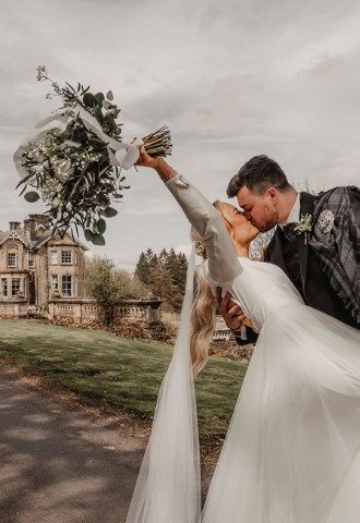 Bride & grom in the grounds at Auchen Castle - a romantic castle wedding venue in Scotland