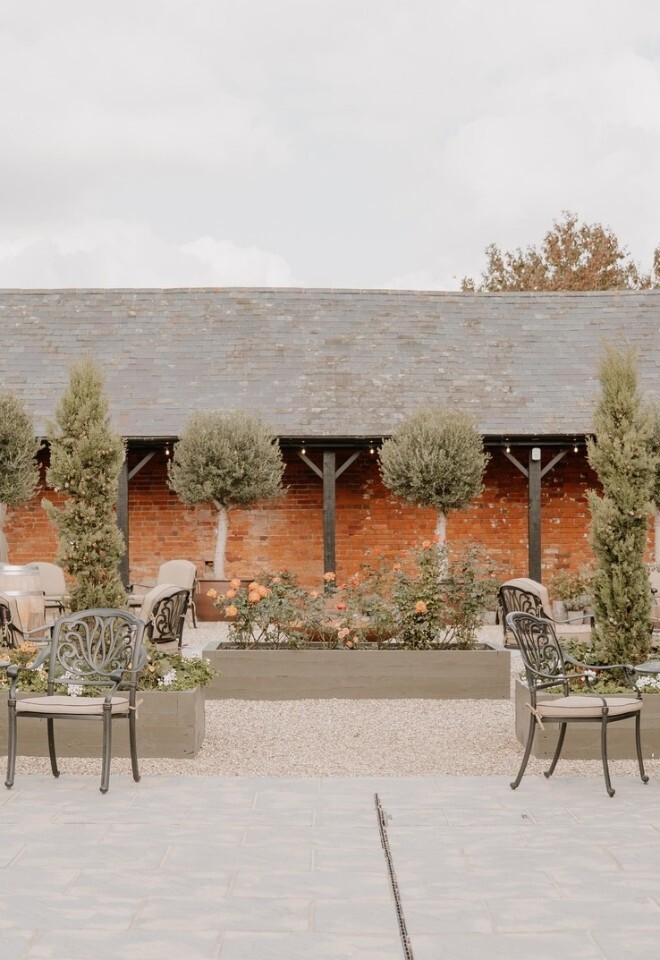 Flowers and furniture in Copdock Hall courtyard