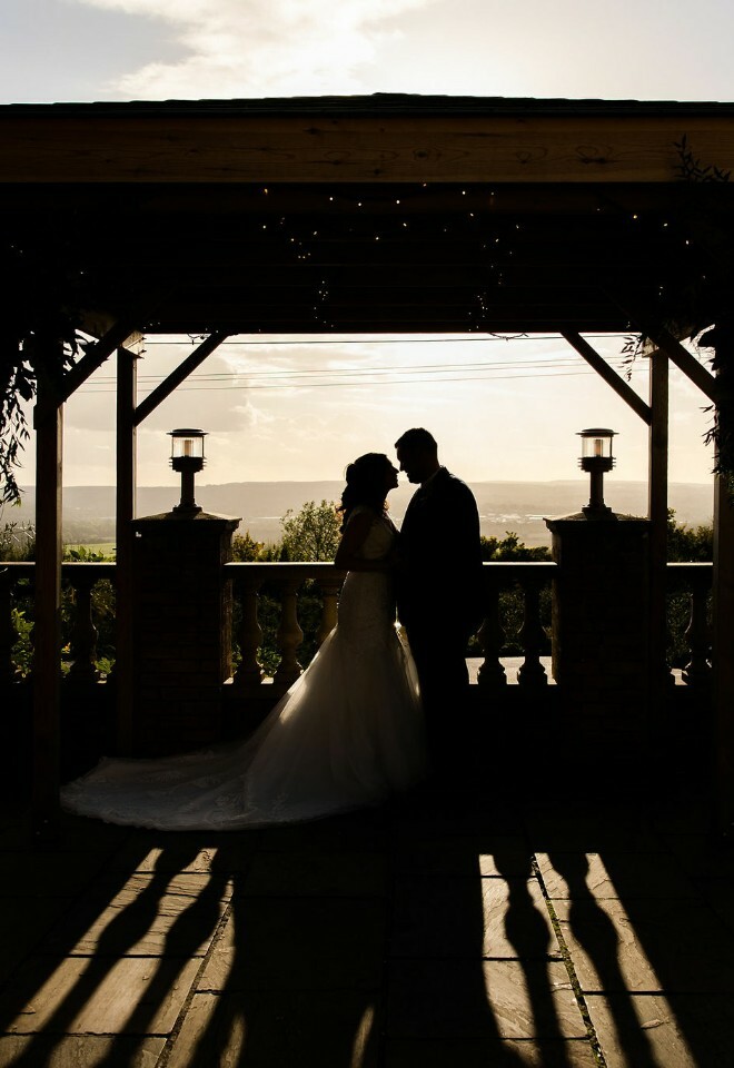 Silhouette of bride and groom on terrace