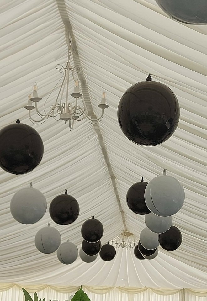 black & white balloons on ceiling of marquee wedding reception in Sussex