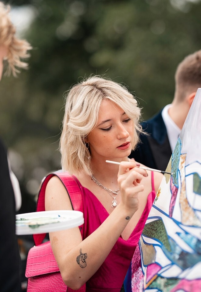 guest painting at wedding