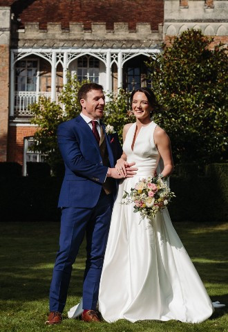 Bride and groom share a laugh outside Nether Winchendon House