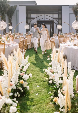 Bride and Groom walking through reception space at Vida Beach Resort Umm Al Quwain