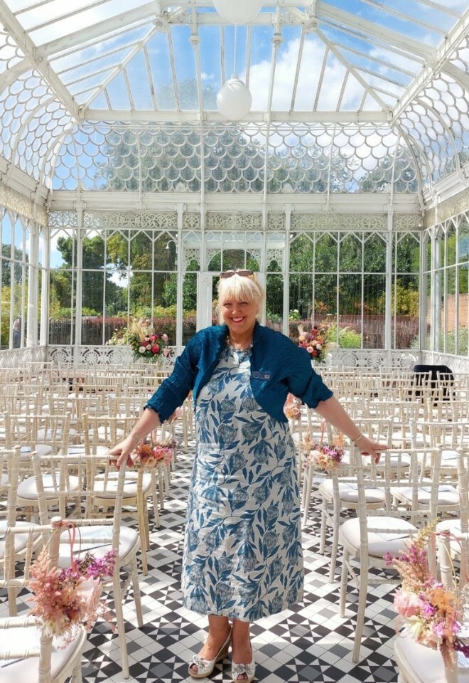 celebrant standing in sunlit glass house