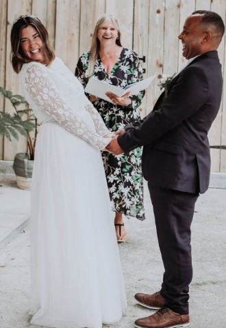 Bride and groom laughing with their celebrant Lisa at Camel Studio