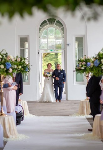 Bride walks down the aisle at Margam Orangery, South Wales