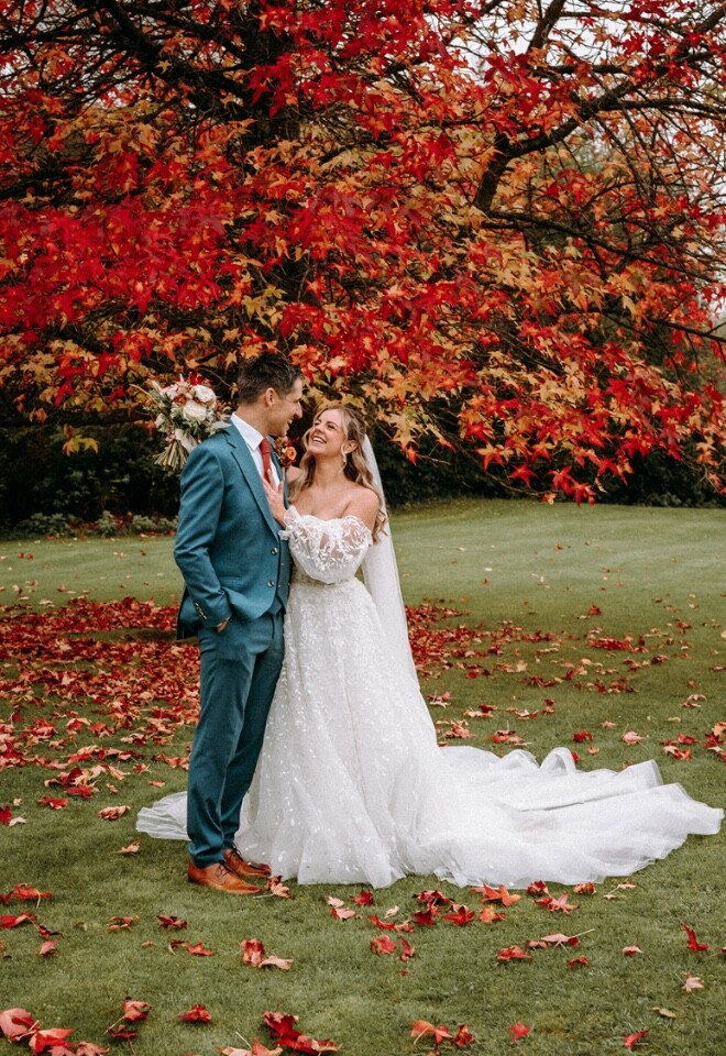 A couples portrait by our famous autumn tree at The Old Mill