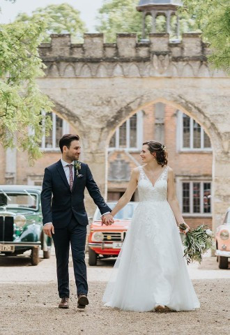 Bride and groom take a walk down the driveway at Nether Winchendon House
