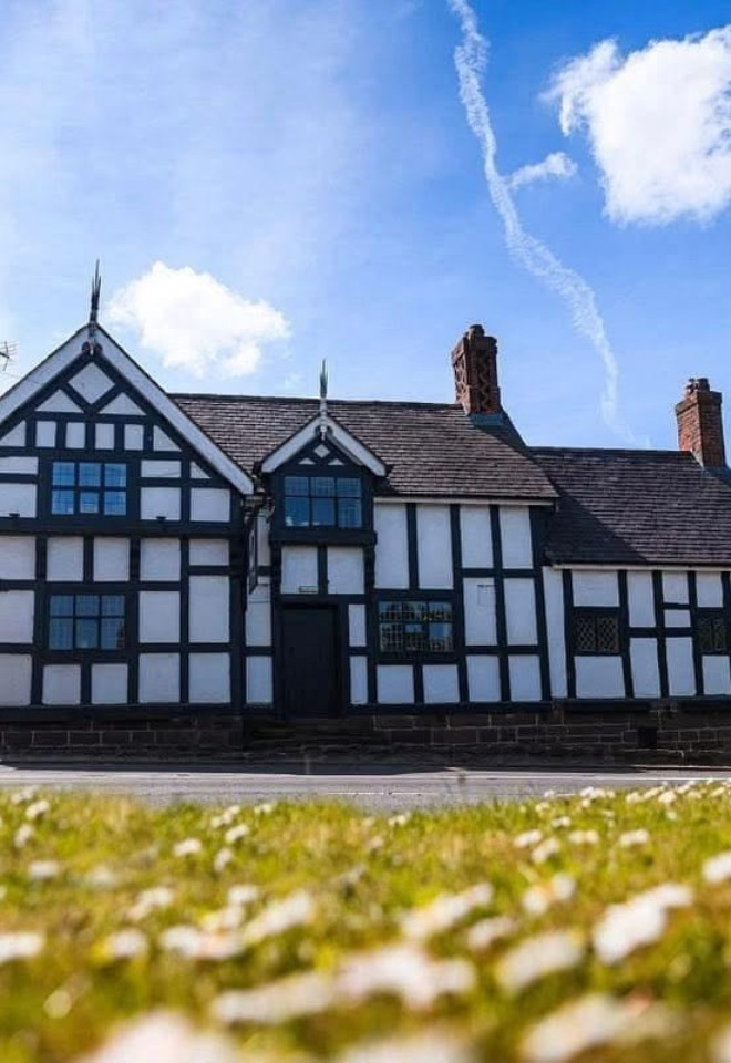 Exterior of The Cock O’Barton, a characterful Tudor-style wedding venue in the Cheshire countryside.