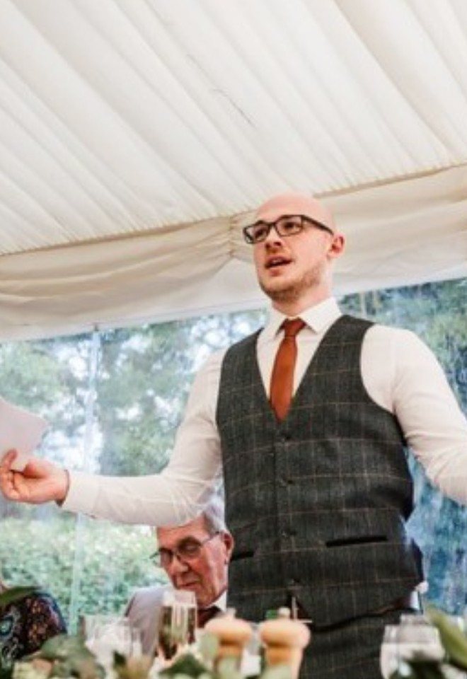 Groom delivering his wedding speech during the marquee wedding breakfast at The Cock O’Barton.