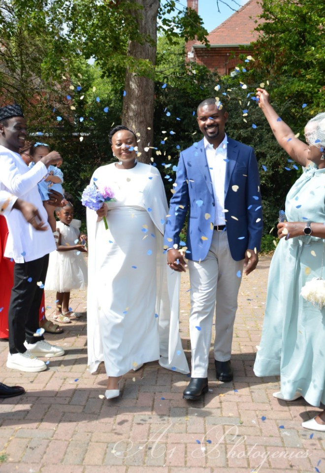 african wedding with bride and groom with confetti being thrown at them by the guests