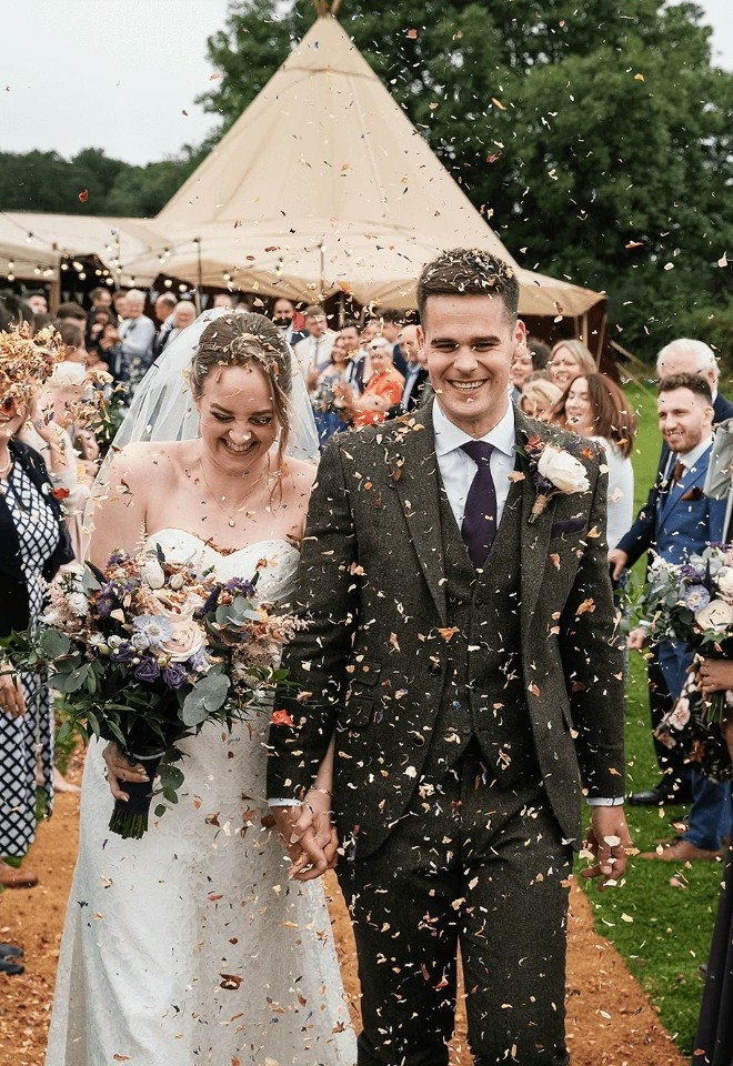 Outdoor wedding with confetti tunnel