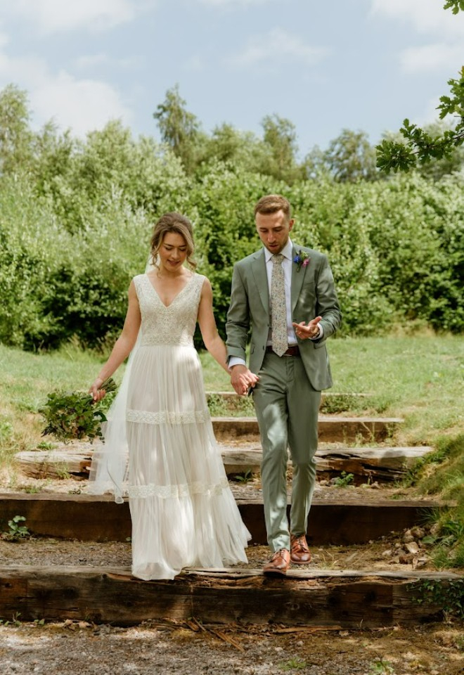 Bride and groom walking down the steps at Higher Holcombe wedding venue 