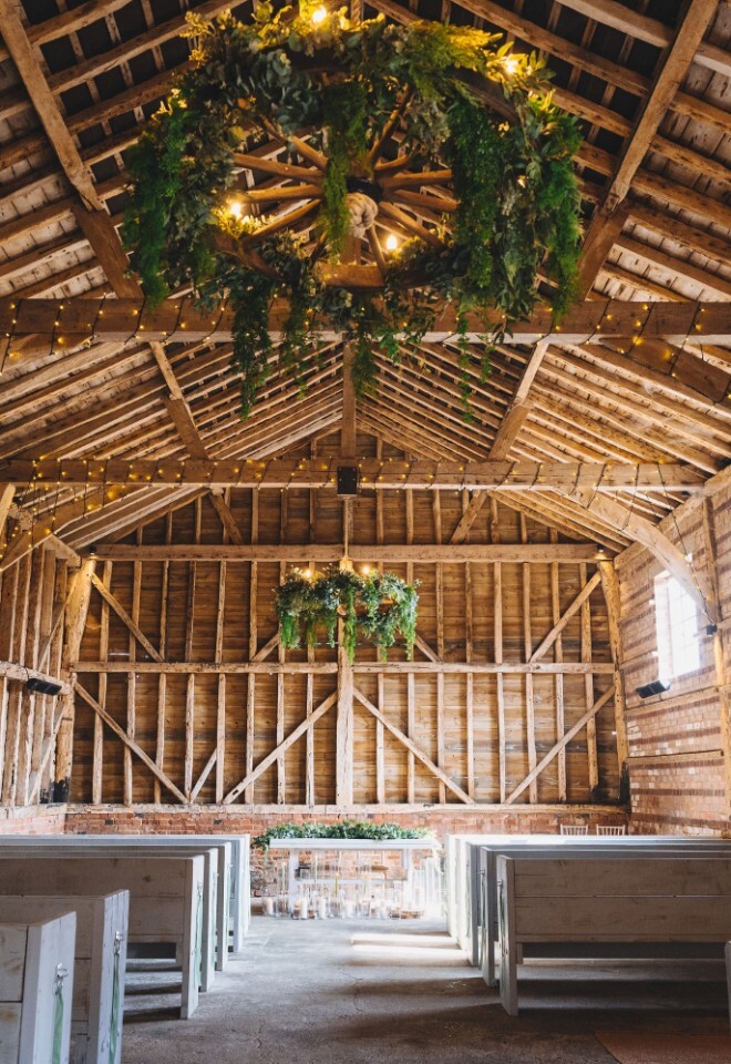 Inside one of the barns ready for a couple to walk down the aisle in a Hertfordshire wedding venue