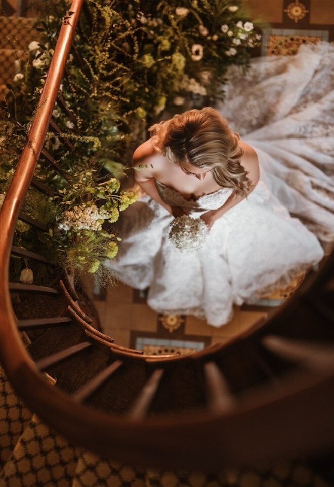 Looking down at a Bride on the Spiral Staircase at Glewstone Court
