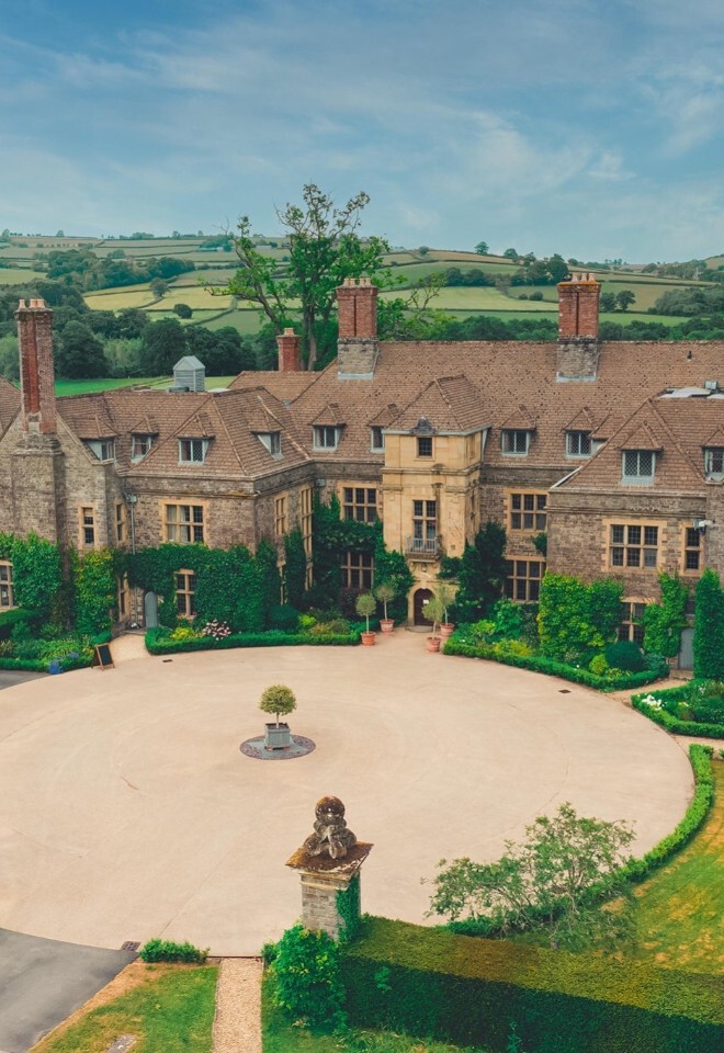 Llangoed Hall House with circular gravel drive aerial view.