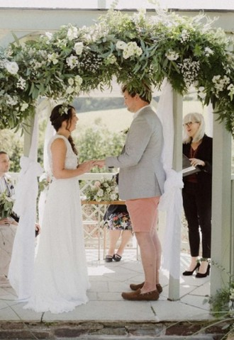 Ceremonies by Sally, leading a celebrant wedding, stood with the couple surrounded by flowers
