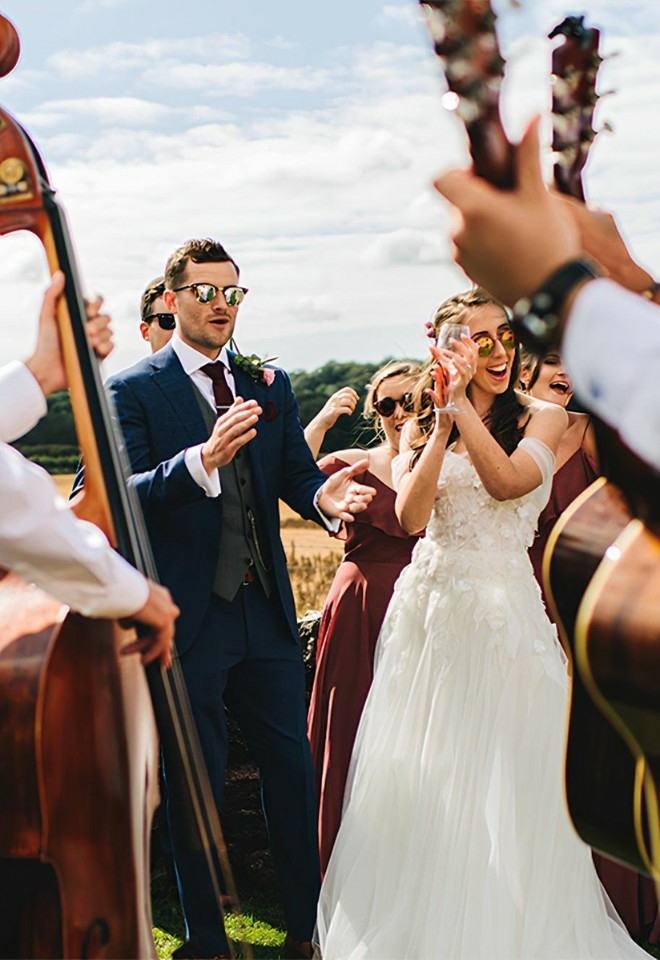 bride & groom stood with muscians playing the double bass for their wedding music entertainment from alive network agency staffordshire