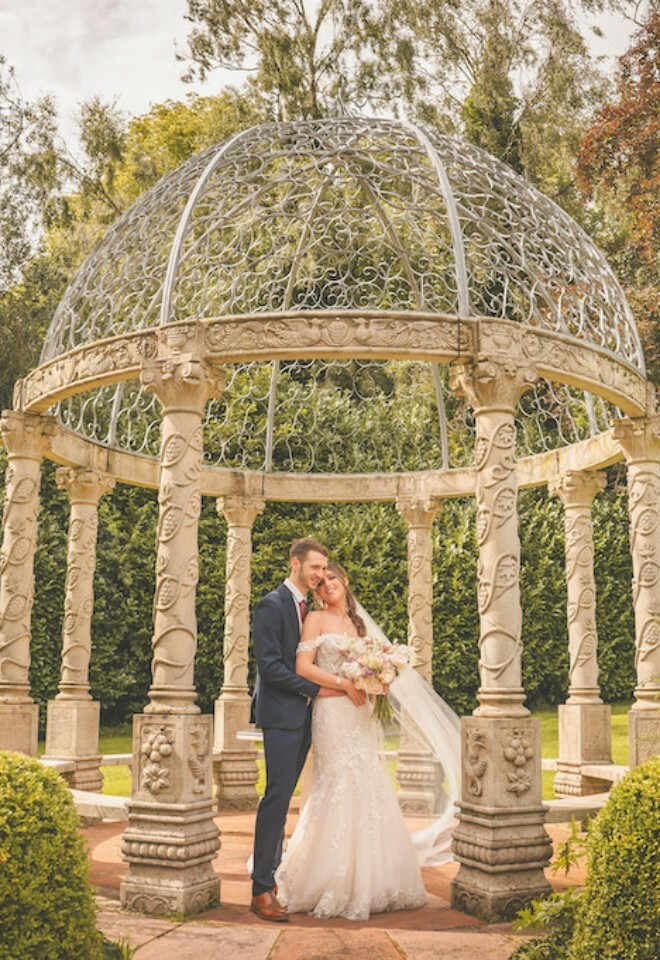 Couple by the outdoor ceremony structure