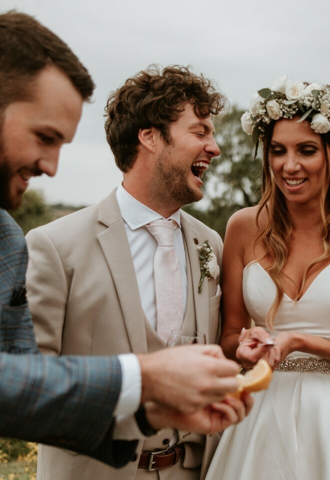 the bride and groom are laughing as they are wowed with personalised magic just for them