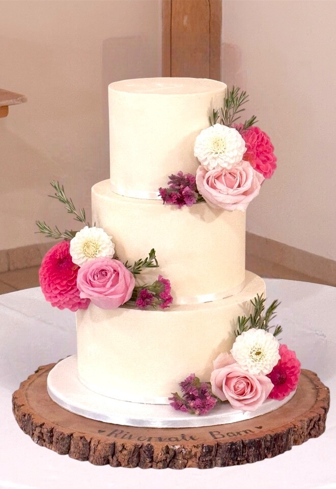 White chocolate ganache cake decorated with beautiful fresh flowers 