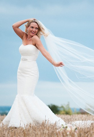 Bride wearing wedding dress with veil floating in the summer breeze, Trunkwell House, Berkshire, wedding photographer Paul Griffiths