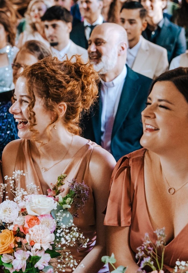 Bridesmaids and guests laughing during UK wedding celebrant ceremony