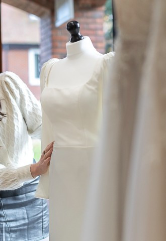 Lady in Your Story bridal boutique with dress on mannequin