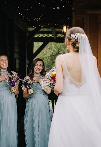 Bride reveals wedding look to bridesmaids at Skylark Weddings