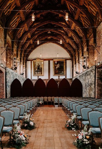Wedding ceremony with wooden beams inside Hatfield House