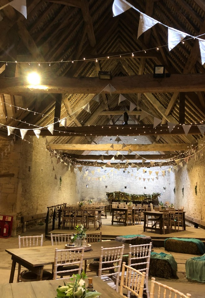 Rustic trestle tables with chivari chairs and straw bales