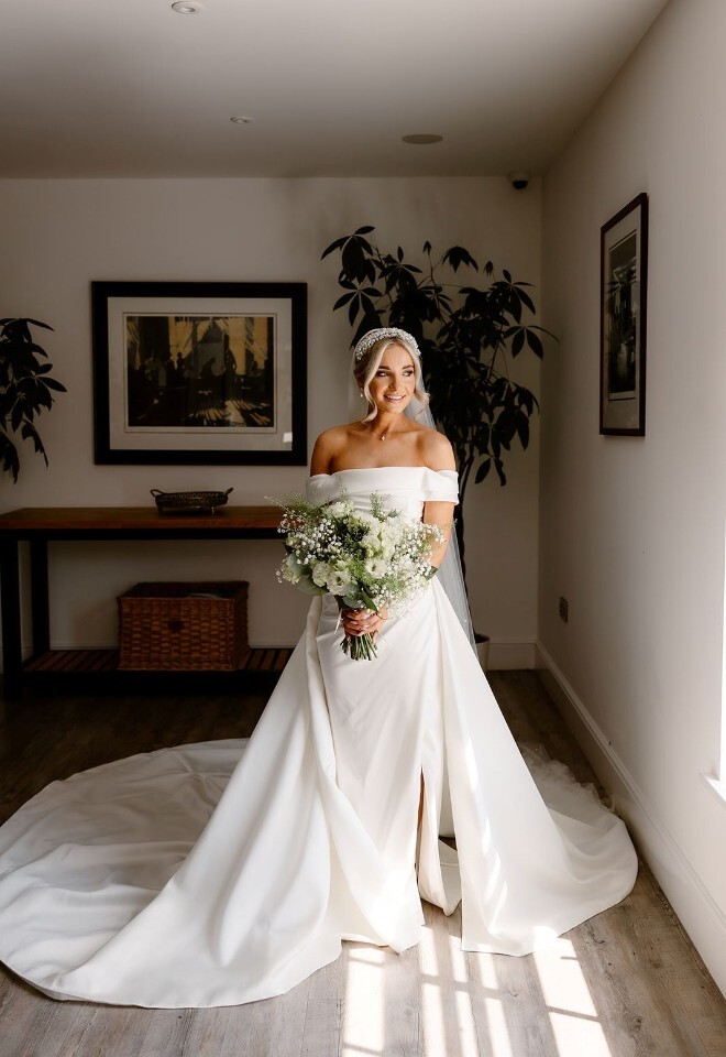 Bride holding sage green and white bridal bouquet at modern barn wedding venue in Somerset by FLOWERS BY ANYA