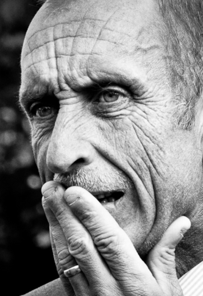 Candid image in black and white of an elderly male wedding guest