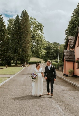 Bride and groom exploring the grounds at Cwrt Bleddyn Hotel, Monmouthshire