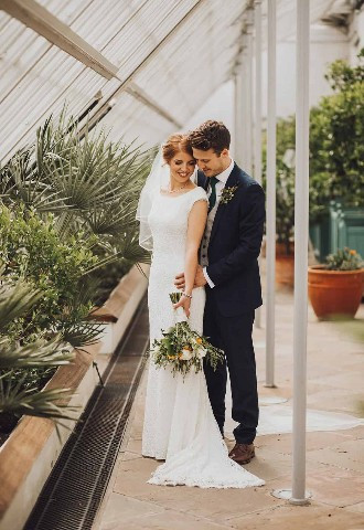Bride and groom pose at Margam Orangery, Neath Port Talbot