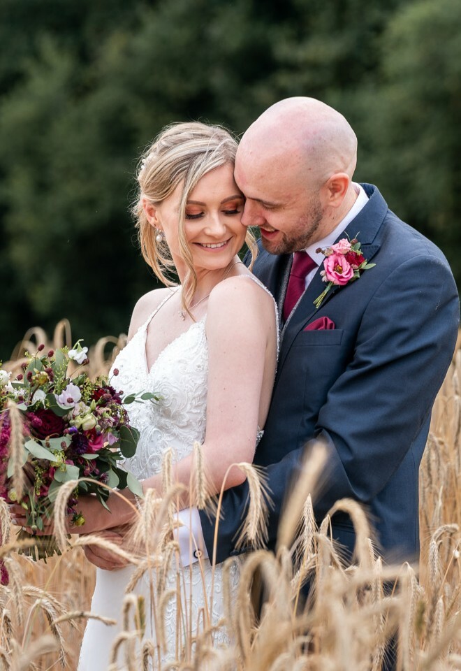 bride and groom in corn field