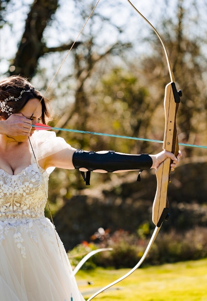 Bride doing Archery