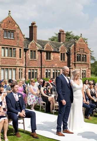 Bride and groom at their outdoor wedding ceremony at Colshaw Hall