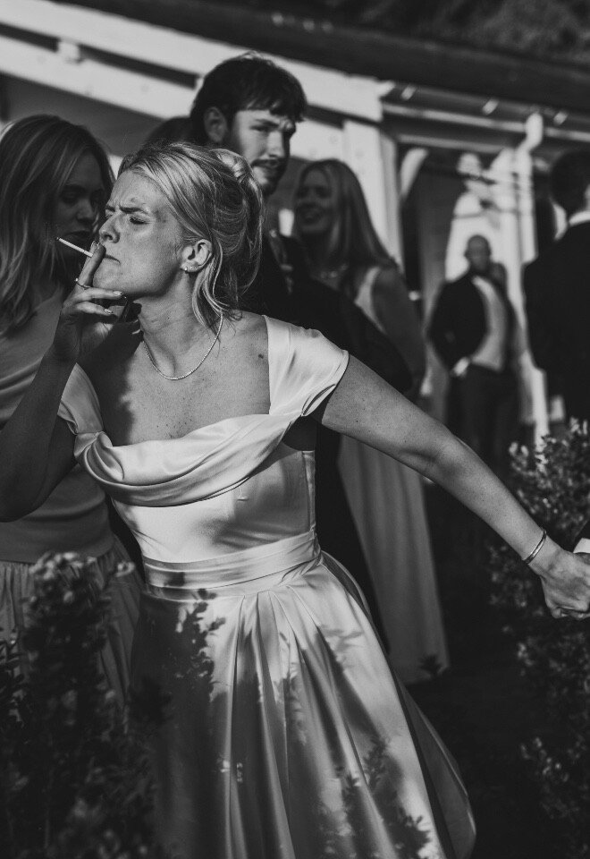 Black and white documentary wedding moment during lively reception