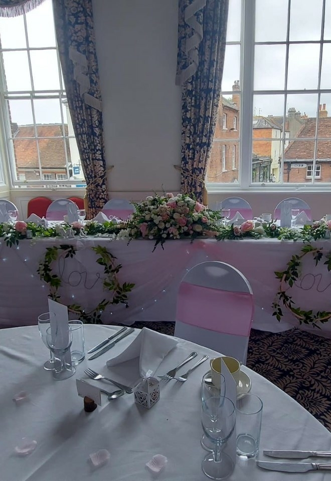 Top table wedding decorations from Inflate 2 create pink and white theme at Sussex wedding venue