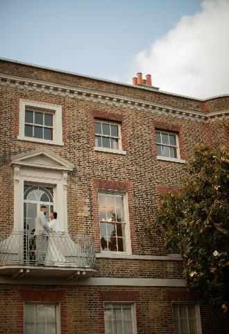 Valentines Mansion bride & groom on the balcony, Essex wedding venue